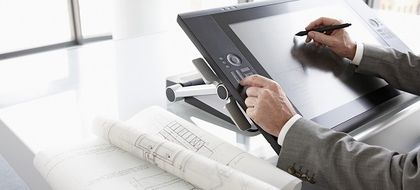 An architect draws plans on a digital drawing board.