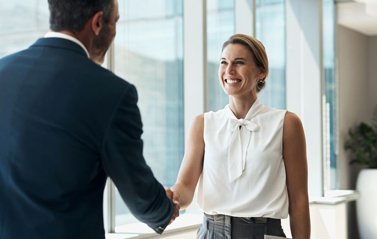 Two people shake hands