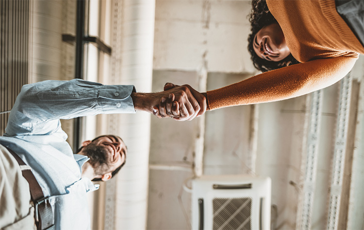 Two employees are shaking hands