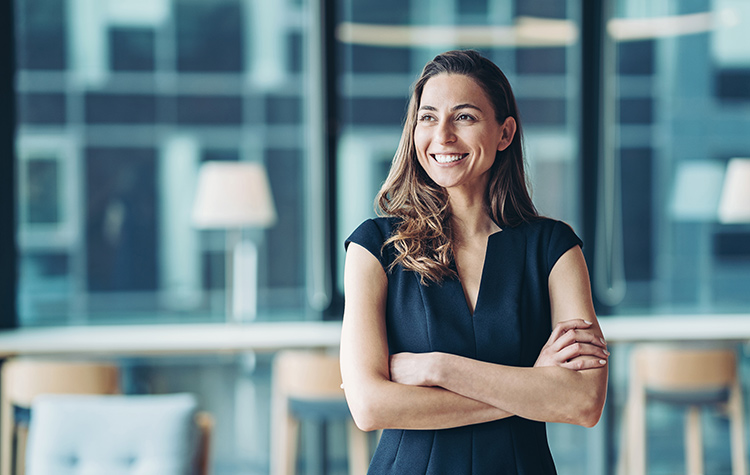 Chief physician stands in her office and smiles
