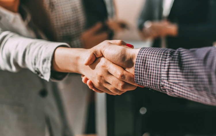 Two hands perform a handshake